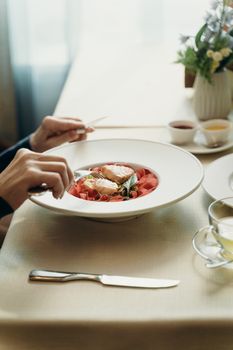 A sophisticated presentation of smoked salmon and vegetables in a fine dining setting.