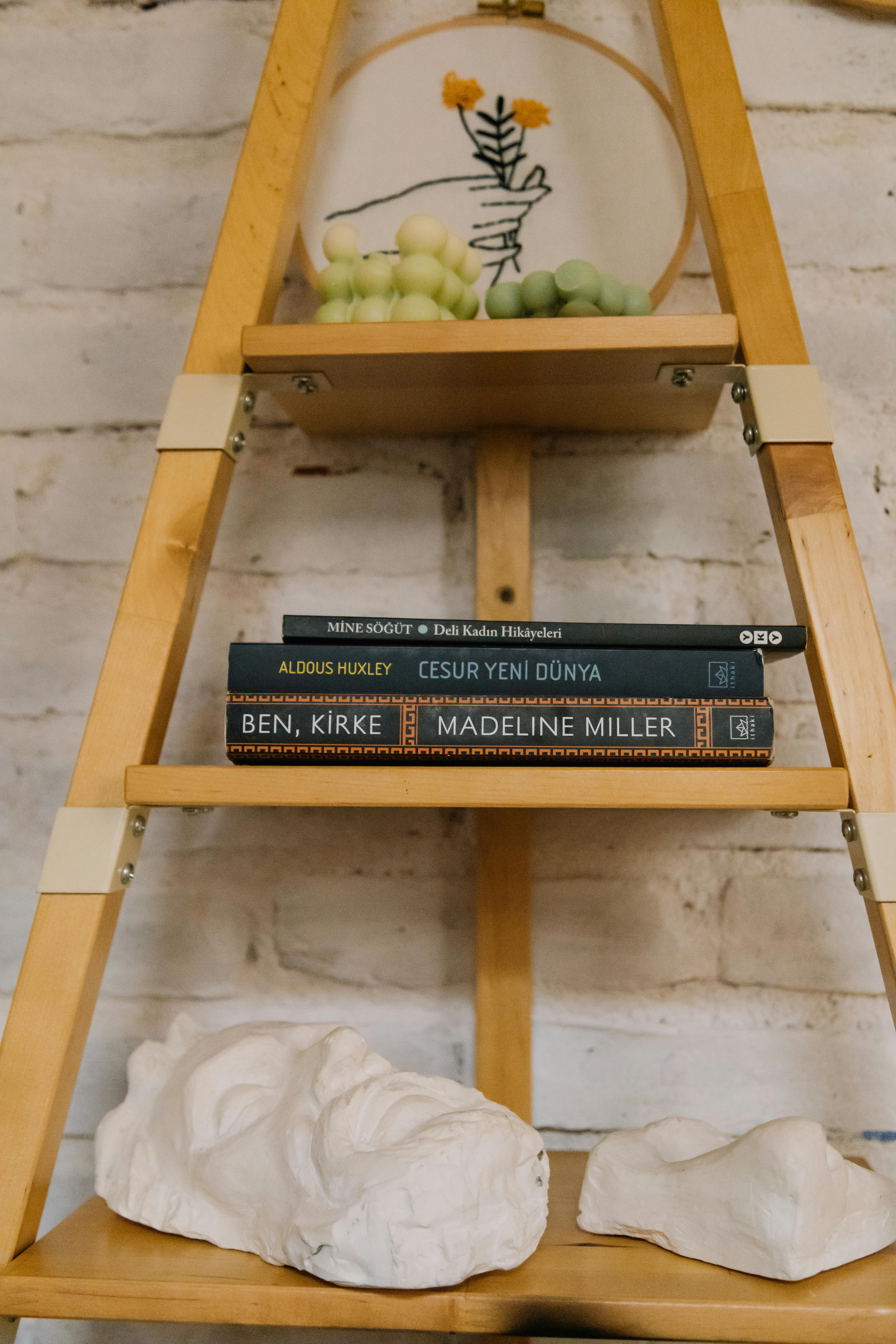 Free Stylish wooden bookshelf with books and decor, perfect for interior design inspiration. Stock Photo