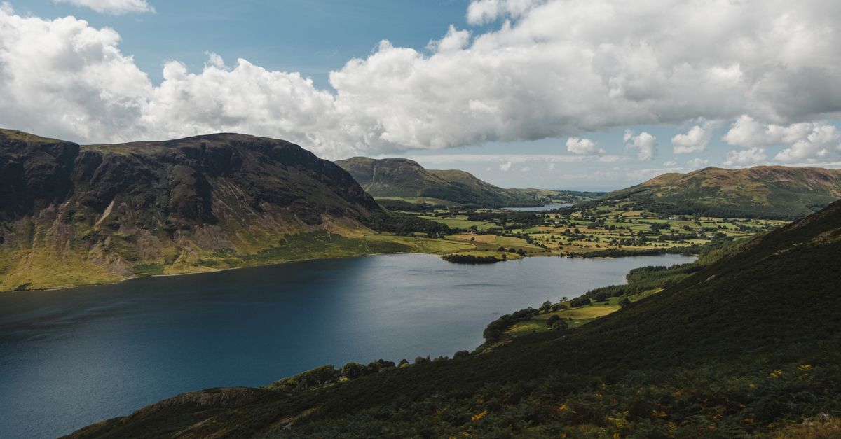 Explore the stunning landscape of Ennerdale Water with mountains and lush greenery.