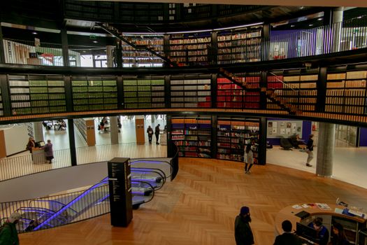People in modern library with books