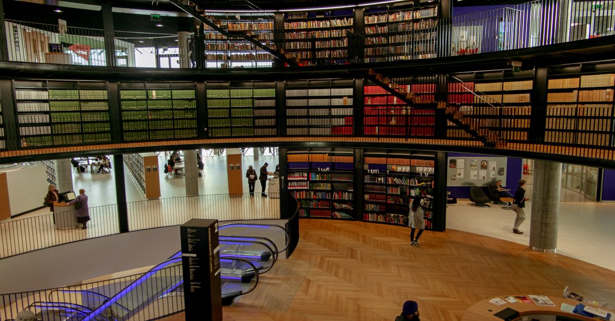 People in modern library with books · Free Stock Photo