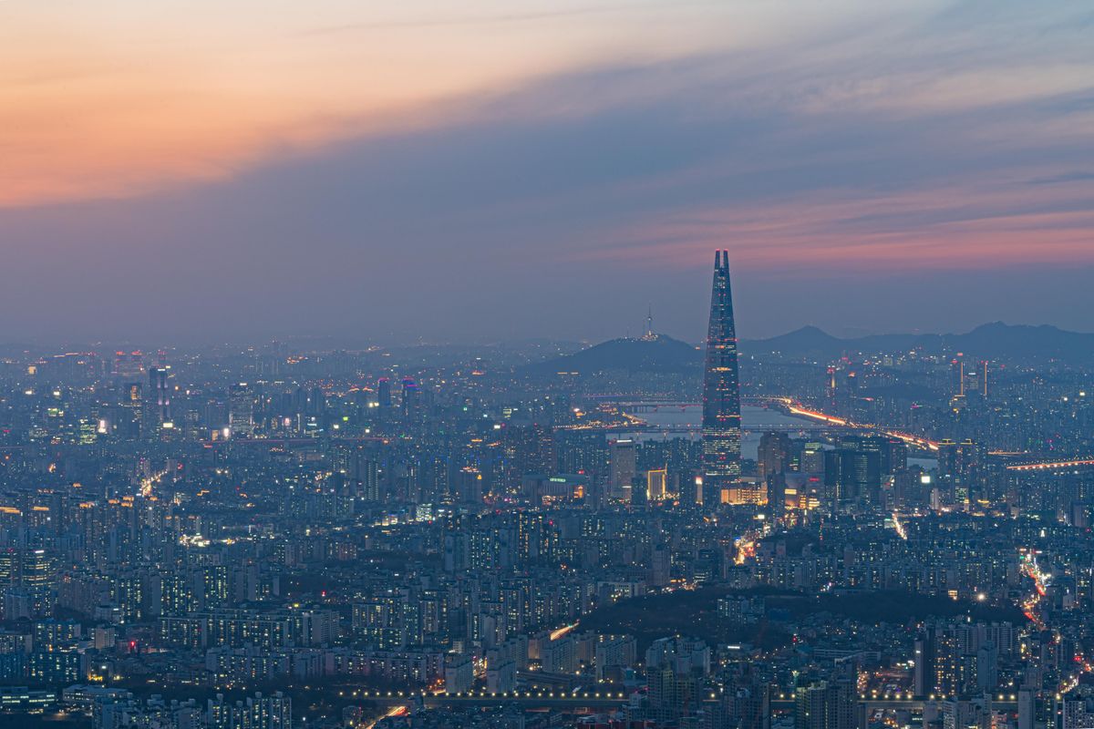 Lotte World Tower and the Seoul skyline at dusk.
