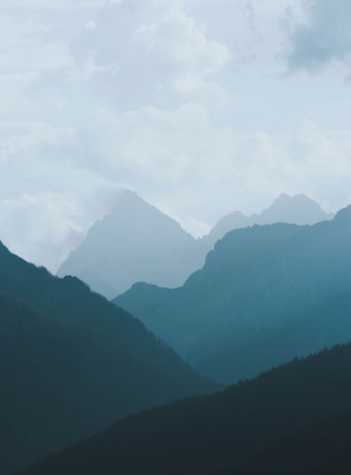 Free Majestic misty layers of mountain ranges in Berchtesgaden, Germany, under a cloudy sky. Stock Photo