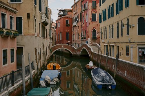 Free Venetian canal with traditional boats and vibrant architecture, capturing the essence of Italy's timeless beauty. Stock Photo
