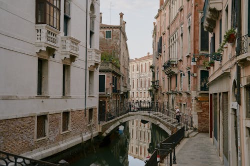 Free Old Buildings and Bridges on Street in Venice Stock Photo
