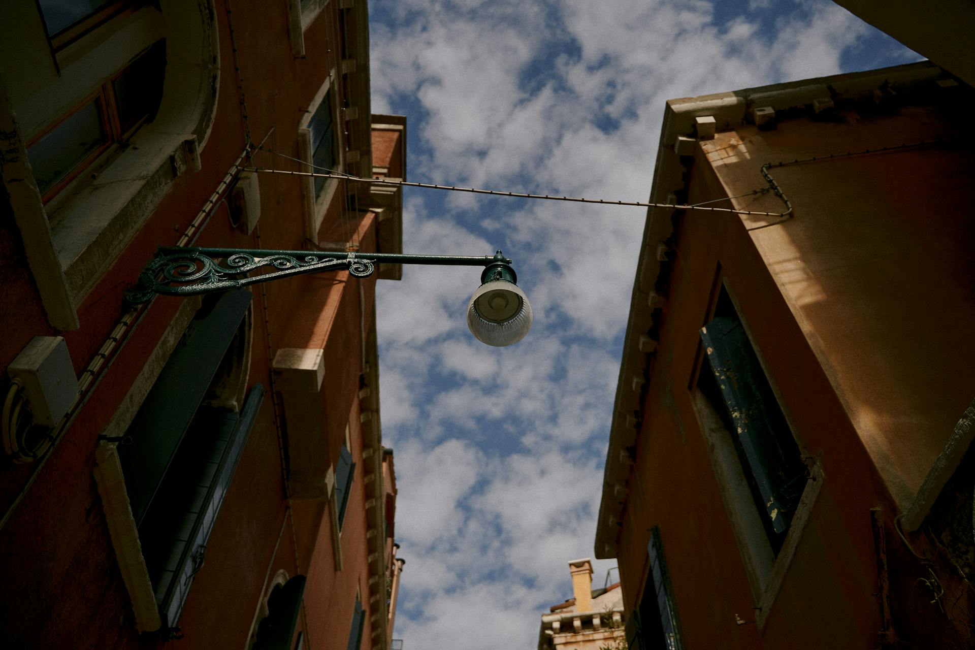 From below exteriors of low rise apartment buildings in old town district under blue sky