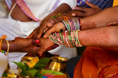 People Holding Hands Together at Hindu Wedding