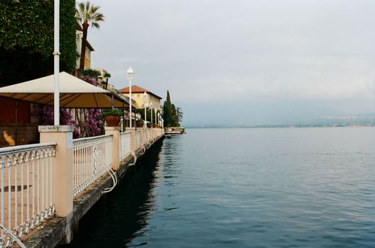 Promenade near calm blue sea in resort