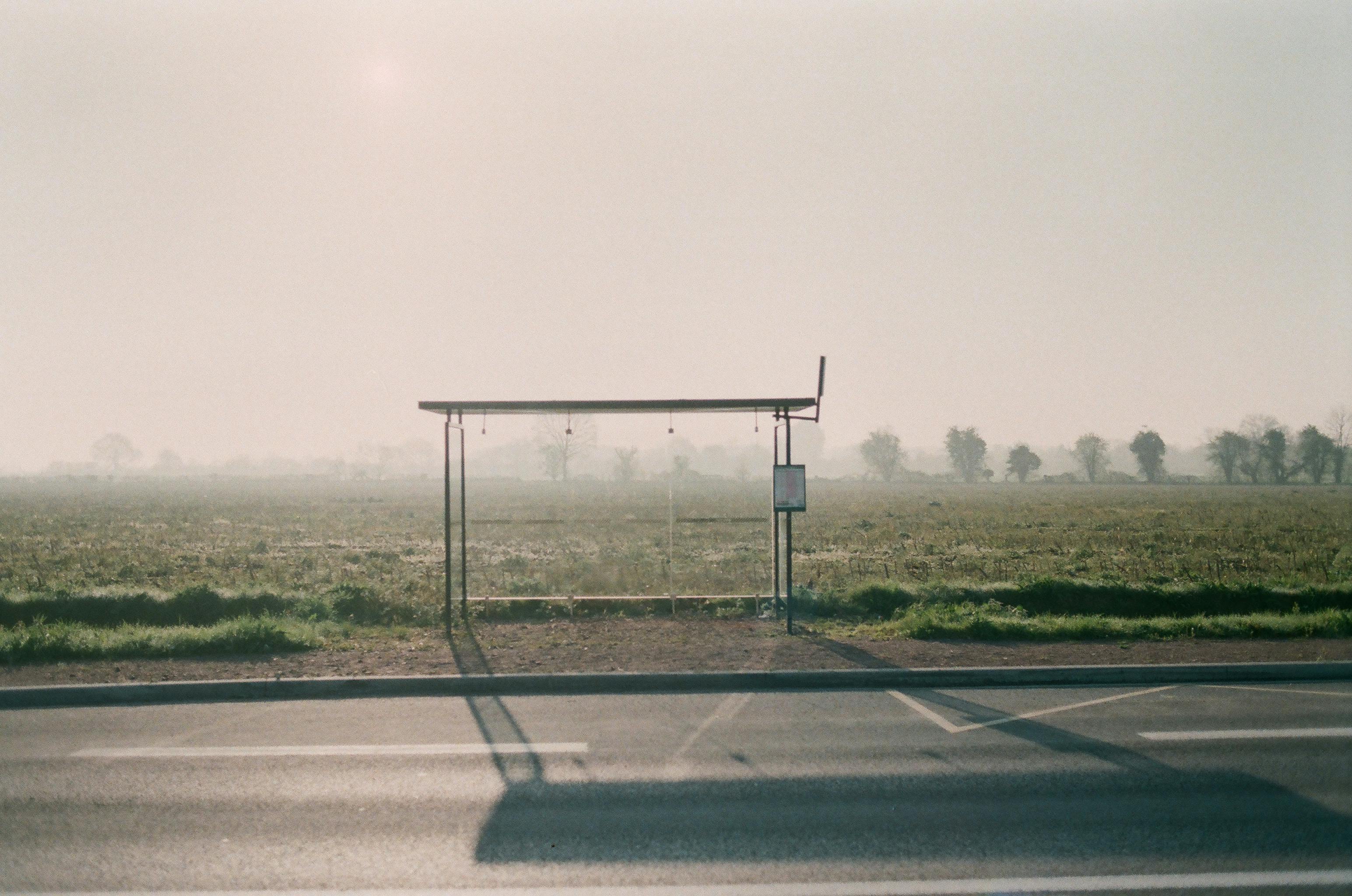 bus stop near road in countryside