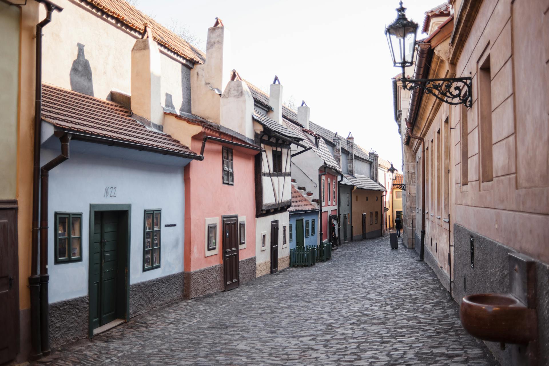 Cobblestone street between old residential house exteriors in town