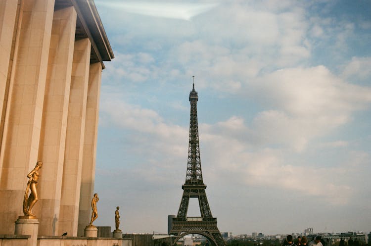 Eiffel Tower And Old Palace With Statues In City