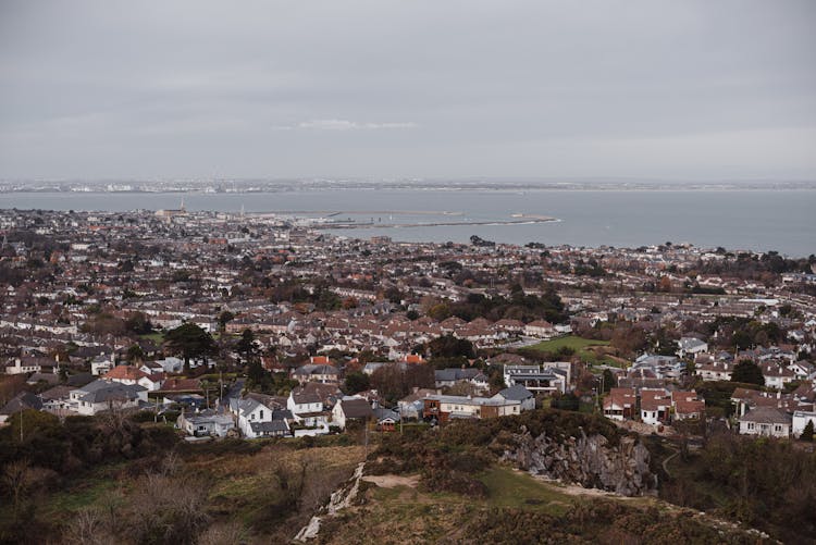 Town With Old Residential Houses And Trees Against Sea