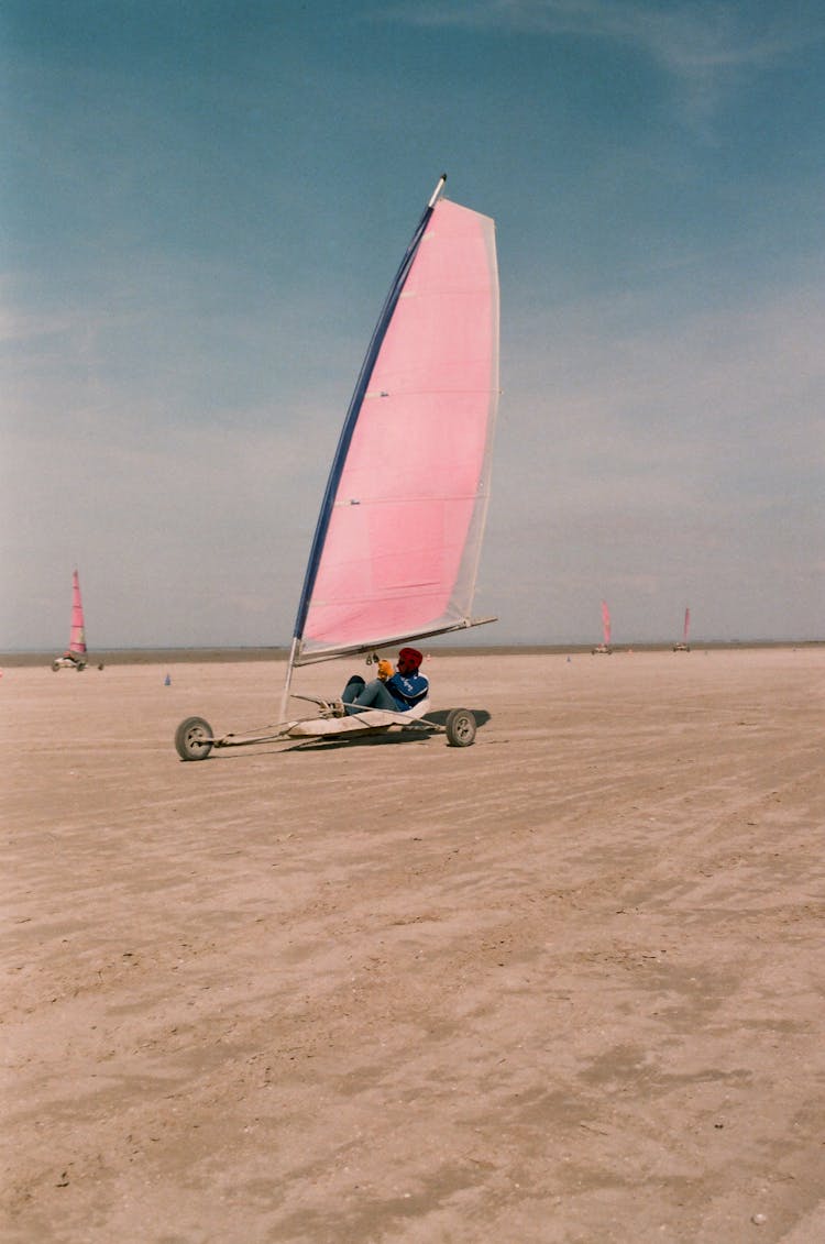 Unrecognizable Man Driving Sand Yacht On Beach