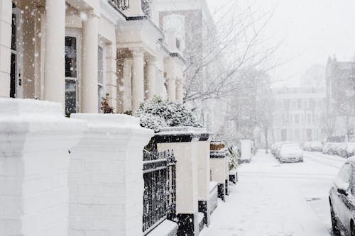 Snowy street with residential buildings