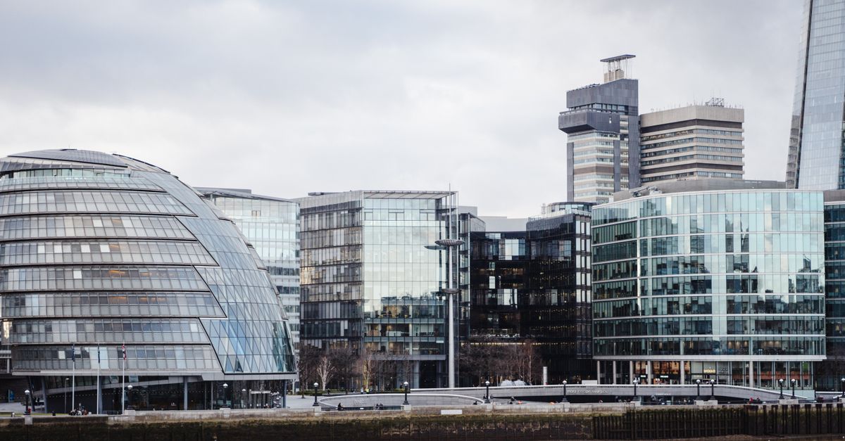 Modern buildings near a river in London used to illustrate UK options trading regulation