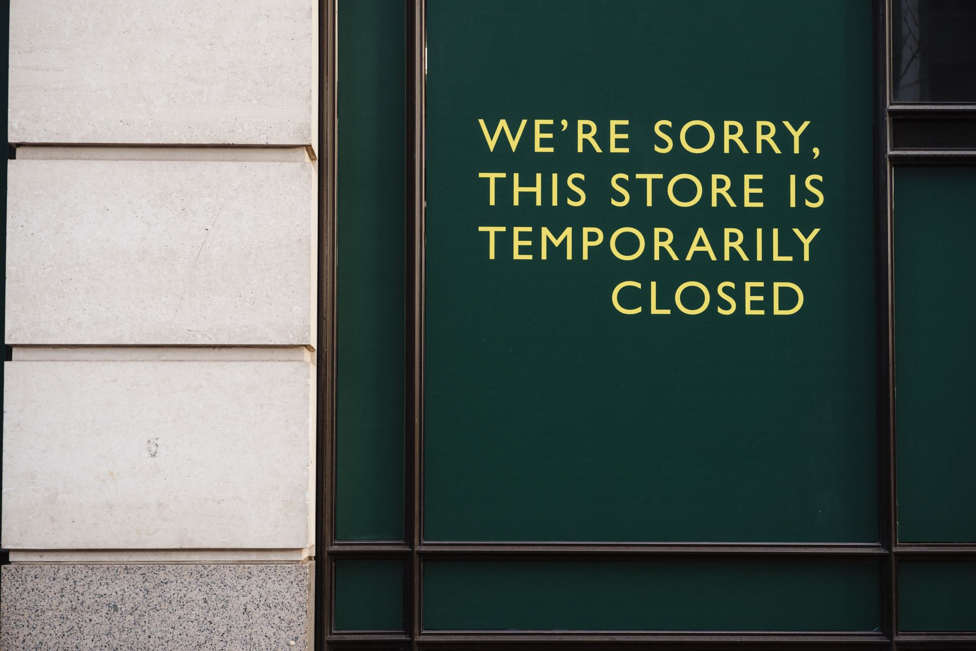 Closed Text Sign on a Building Facade