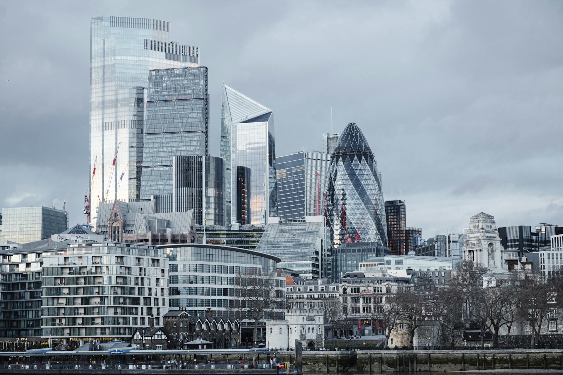 Modern multistory business centers with geometric architecture located on street against cloudy sky in downtown of London city in financial district