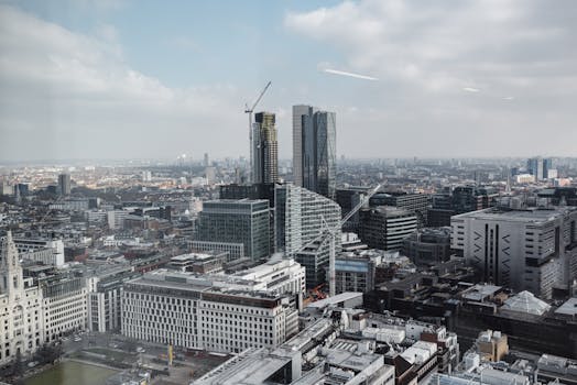 Various buildings and skyscrapers in modern city district under cloudy blue sky in London