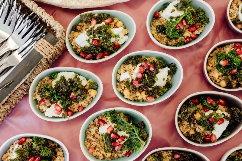 Bulgur grain bowls with whipped cheese, kale and pomegranate — photo by Olga Lioncat on Pexels