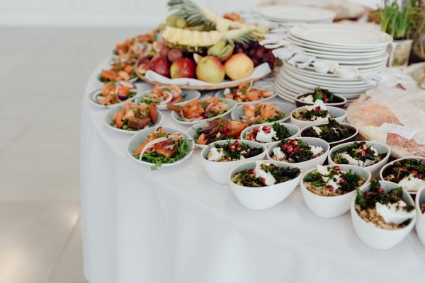 Bowls of grain salad served on a white table — photo by Olga Lioncat on Pexels