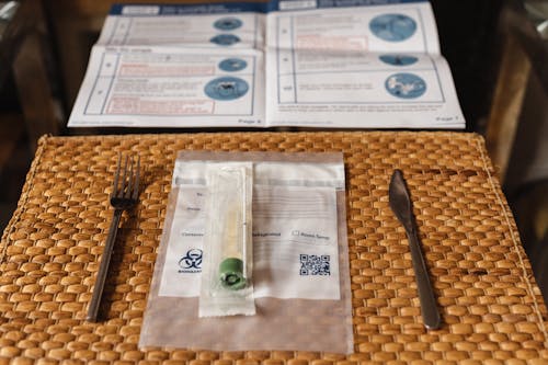Swab Testing Kit on a Straw Placemat on a Glass Table