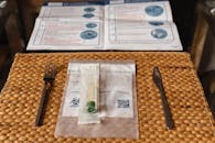 Swab Testing Kit on a Straw Placemat on a Glass Table