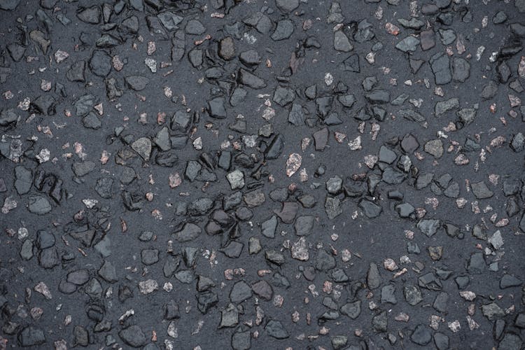 Little Stones Of Gray Wet Asphalt Road