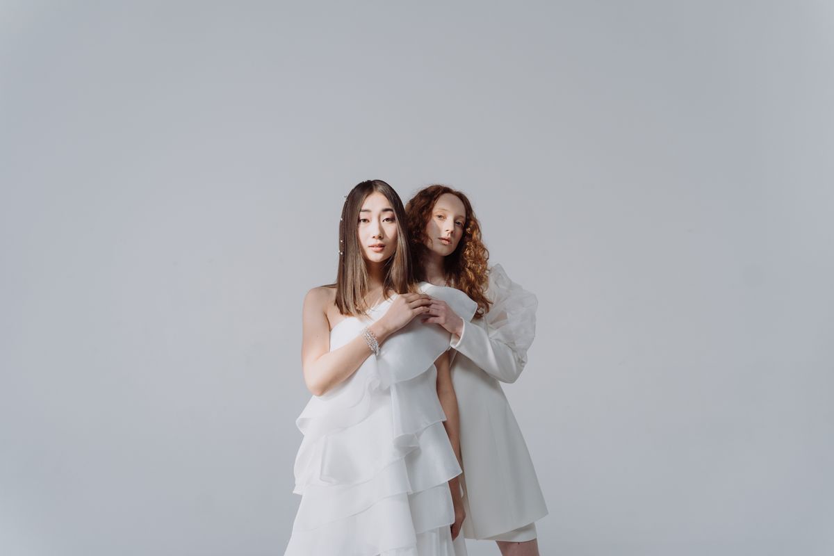 Women in voluminous white ruffled dresses — the statement ruffle