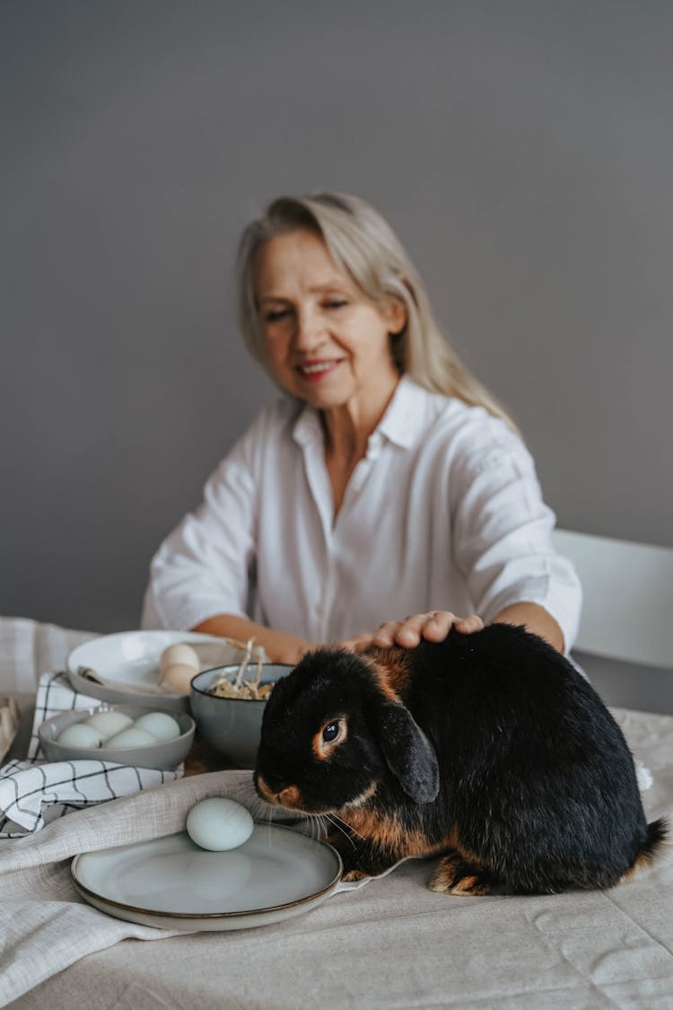 A Woman Petting A Rabbit