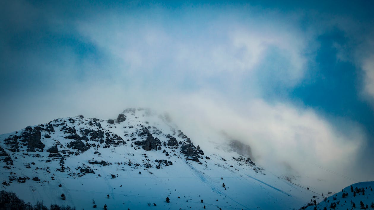 Snow Covered Mountain Under Cloudy Blue Sky