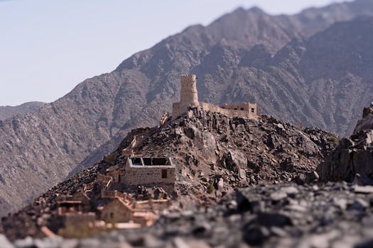 Explore the rustic charm of a historic fortress nestled in the rugged mountains, showcasing traditional architecture.