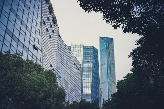 A contemporary cityscape with sleek skyscrapers and green foliage, symbolizing urban harmony.