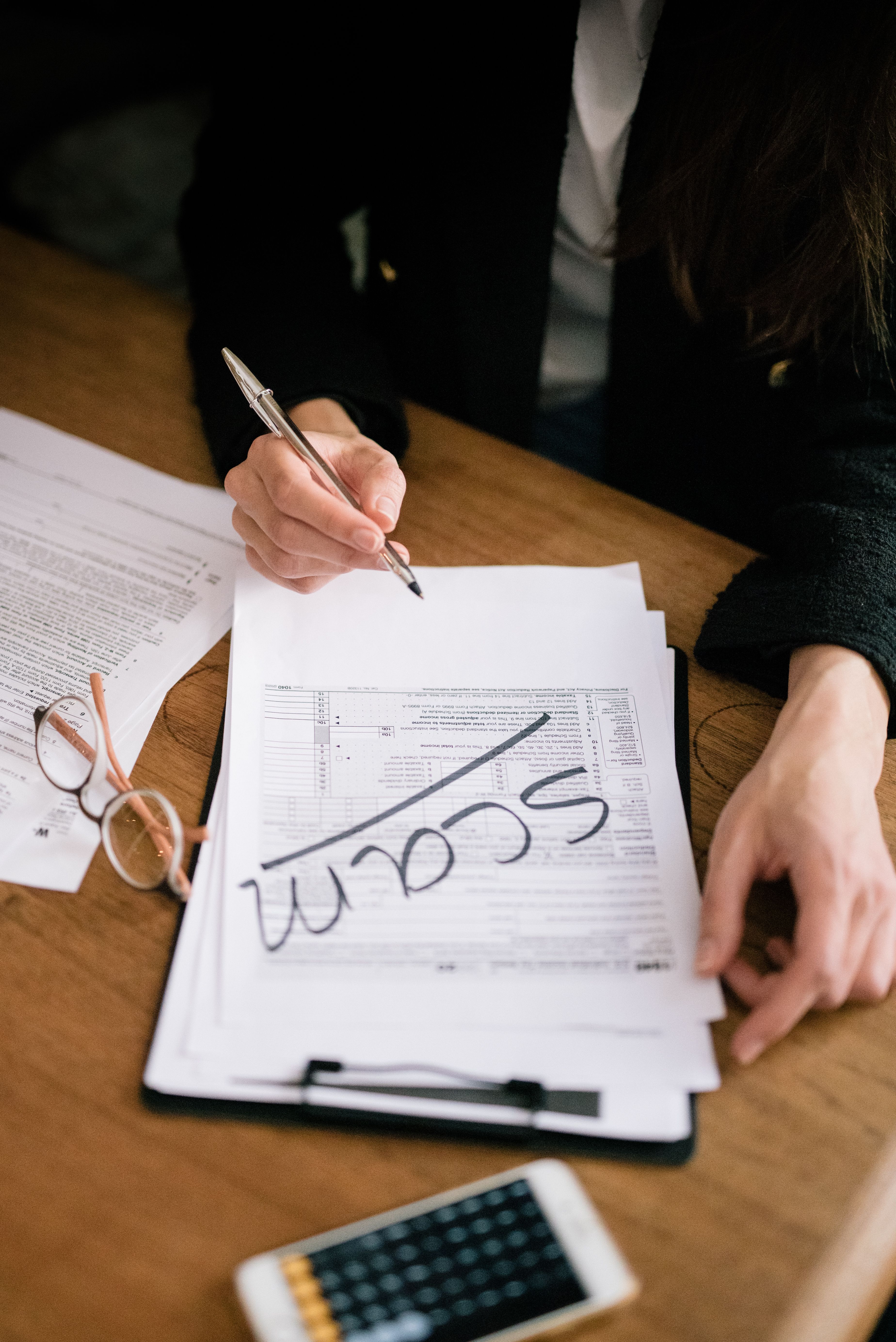 Person Holding a Pen · Free Stock Photo