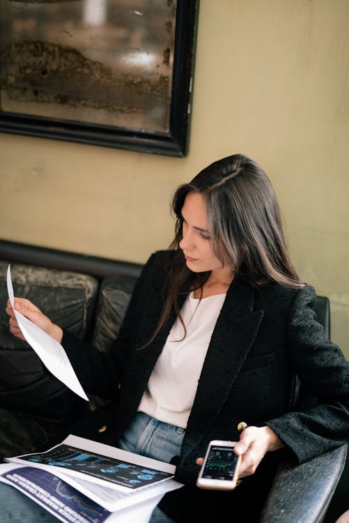 A Businesswoman in Black Blazer Holding a White Paper