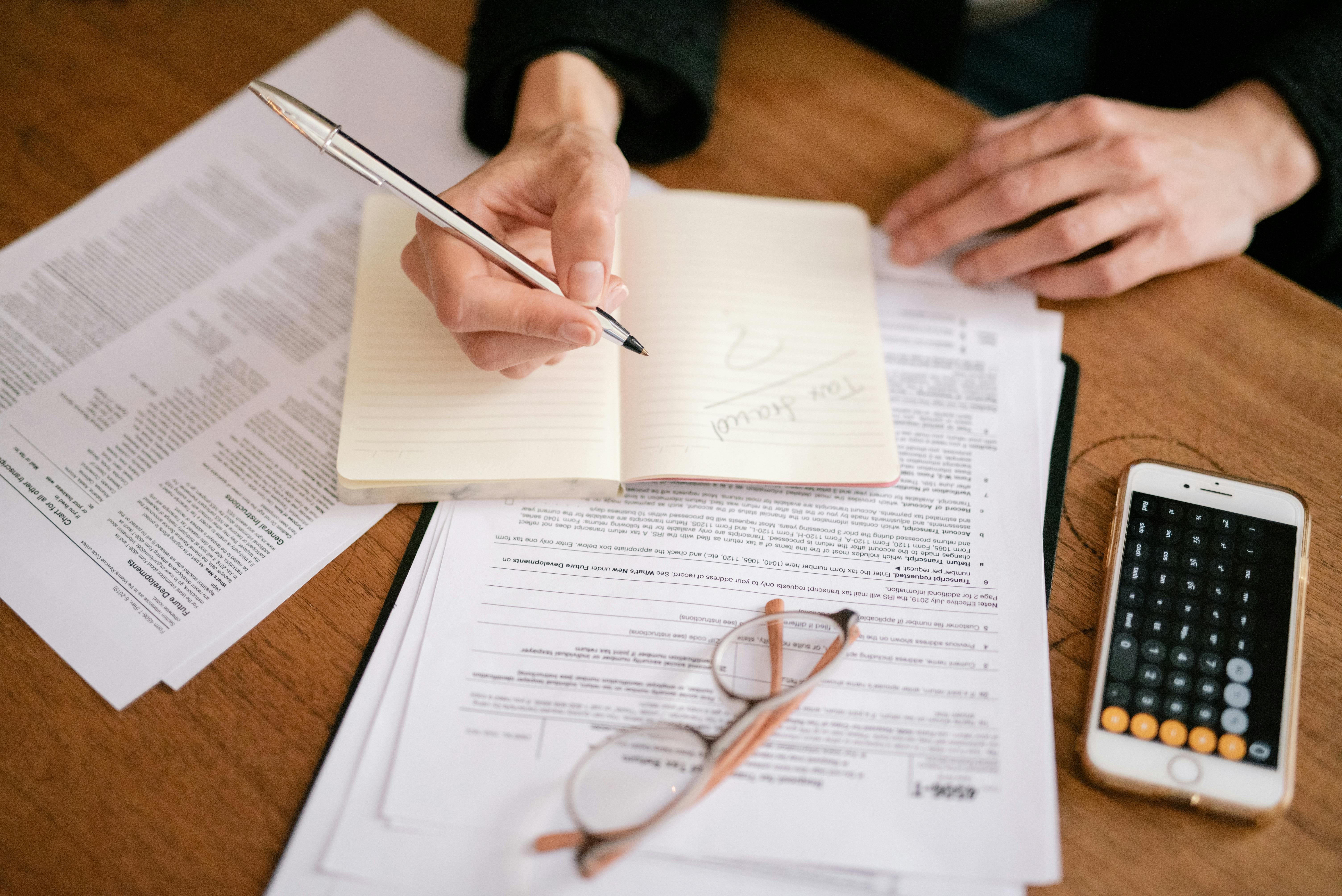 person writing on white paper