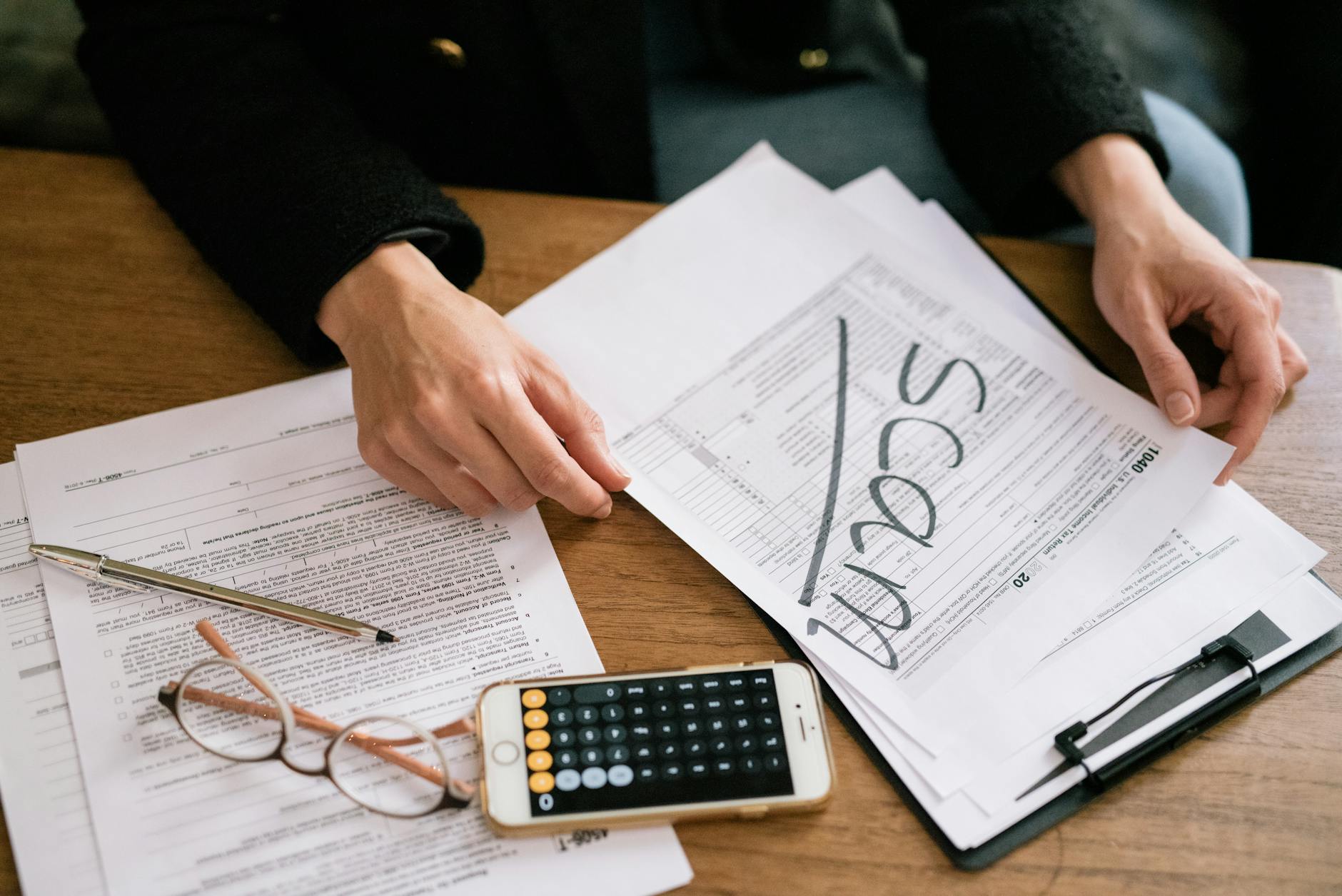 https://www.pexels.com/photo/a-person-holding-a-tax-form-7247409/