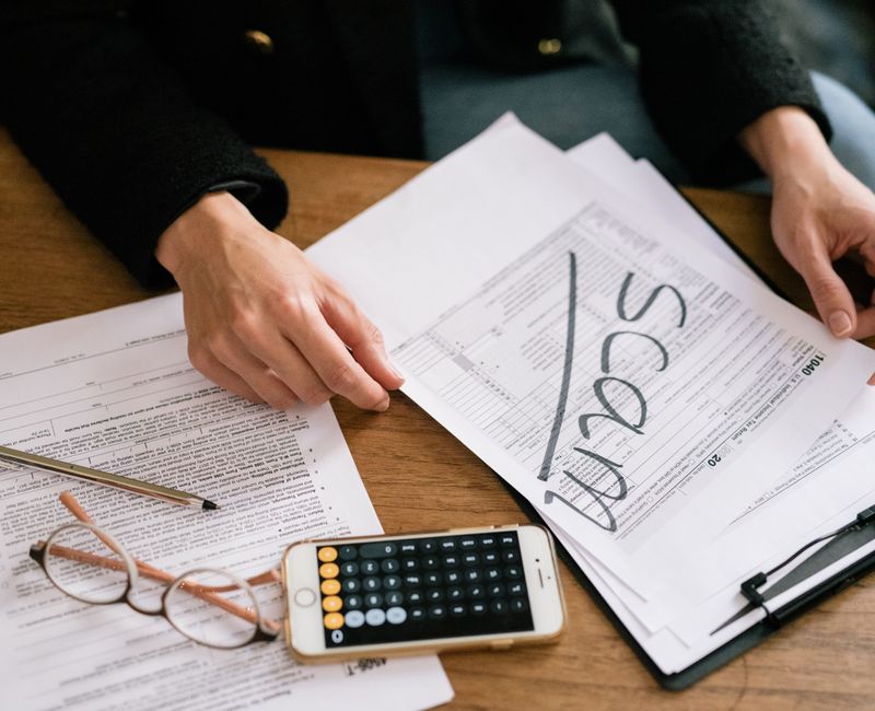 A person reviewing property tax documents with a calculator