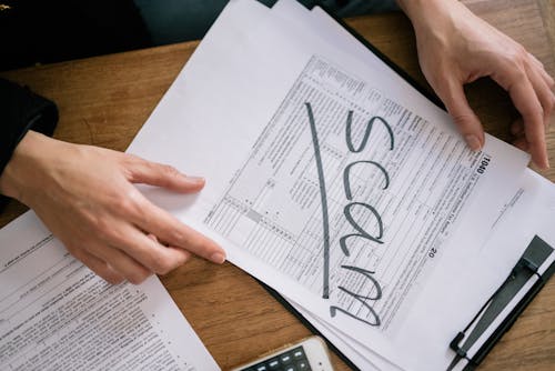 Free A Tax Form with a Word Scam on its Face Stock Photo