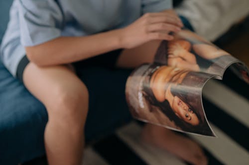 Free A Person Holding a Magazine  Stock Photo