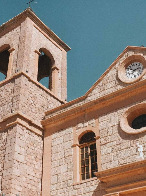 Free Historic church tower and facade in La Paz, Mexico under a clear blue sky. Stock Photo