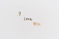 Close-up of 'I Love You' text on white background, perfect for romance themes.