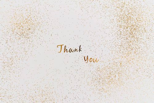 Free A stylish thank you card featuring gold glitter and elegant typography on a white background. Stock Photo