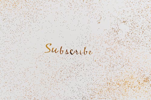 A Word Subscribe in Gold Color Decorated with Scattered Glitters