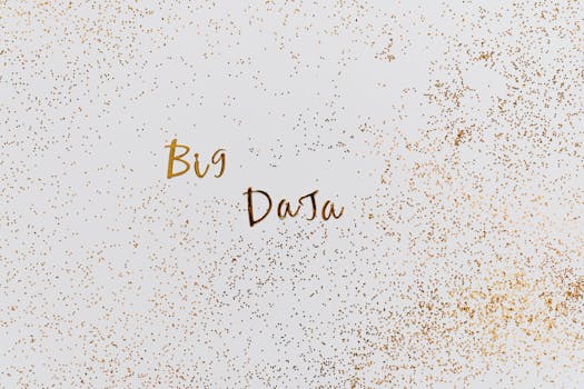 Creative representation of big data with gold particles on white background.