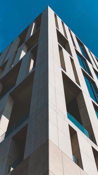 Low angle shot of a modern building in Amsterdam capturing urban architecture.