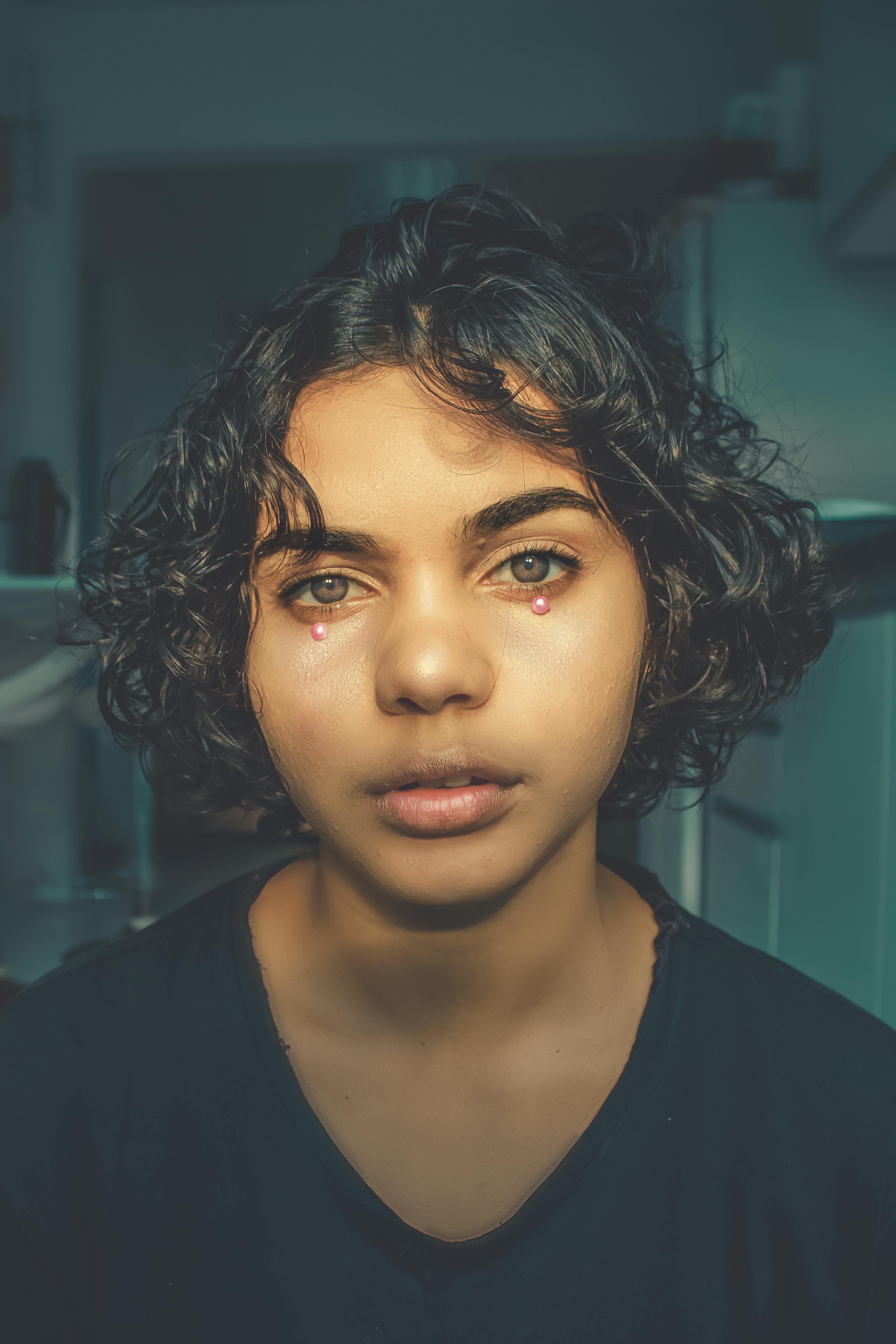 A Woman with Pink Beads Under Her Eyes · Free Stock Photo
