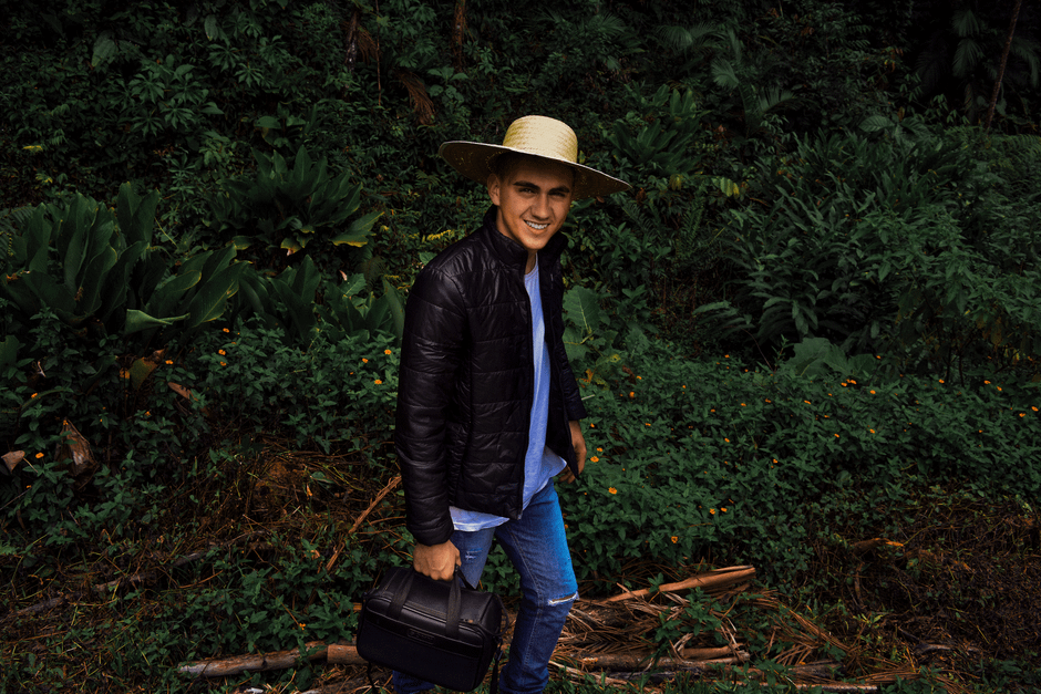 A traveler wearing a straw cowboy hat during a scenic summer road trip A traveler wearing a straw cowboy hat during a scenic summer road trip