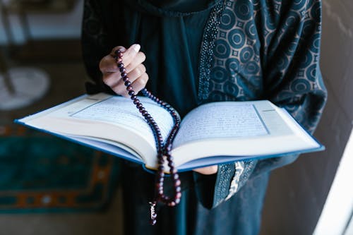 Free Crop Photo Of Woman Holding A Prayer Beads And Holy Book Stock Photo