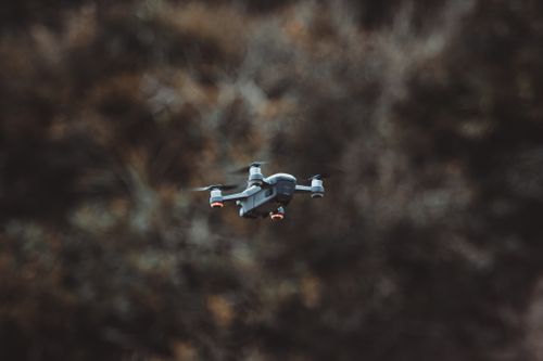 Free A sleek drone soaring swiftly through the air, showcasing advanced aviation technology. Stock Photo