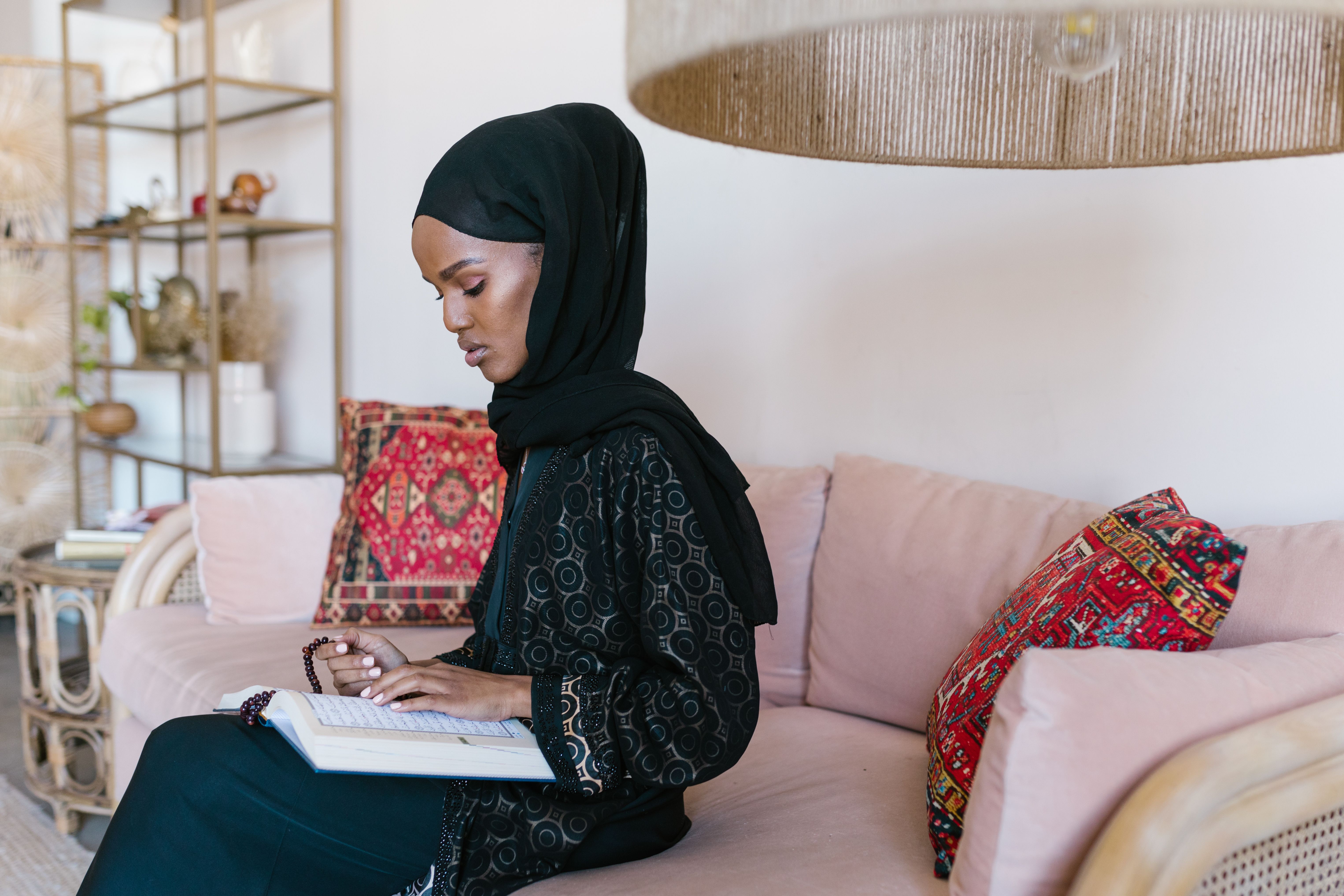 Woman in Black Hijab Sitting on a Couch · Free Stock Photo